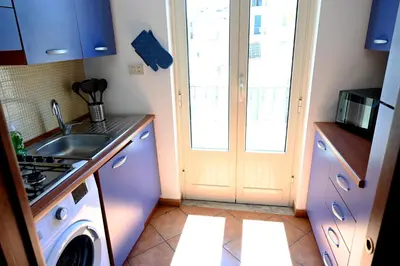 a kitchen with a sink and a washing machine at Politeama Theater Apartments in Palermo