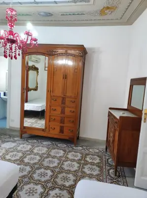 a room with a dresser and a mirror at Casa Giannina in Palermo