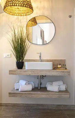 a bathroom with a sink and a mirror at Castellano suites in Castellammare del Golfo