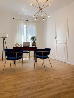 a dining room with a table and blue chairs at Castellano suites in Castellammare del Golfo