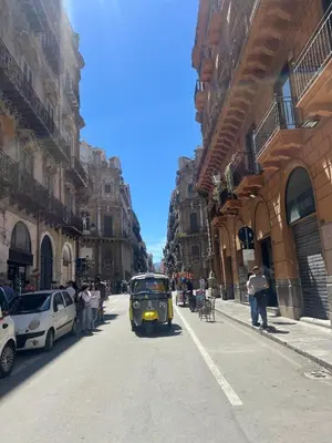 a small car on a city street with buildings at GRETA'S APARTMENT DISCESA DELLE CAPRE in Palermo