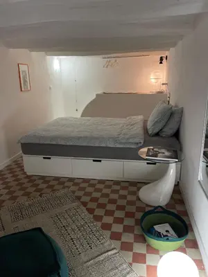 a small bedroom with a bed and a checkered floor at Studio 29 in Palermo