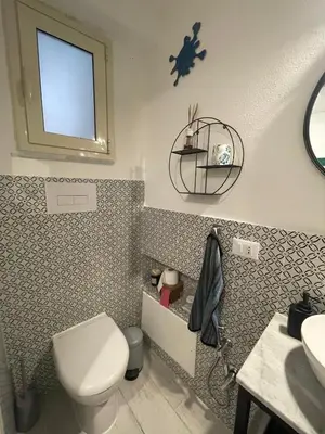 a bathroom with a toilet and a sink and a mirror at Studio 29 in Palermo