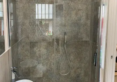 a bathroom with a shower with a glass door at Zisa Private House in Palermo