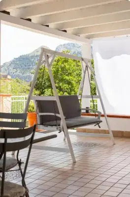 a swing on a porch with a view of a mountain at Il Canto di Euterpe in Palermo