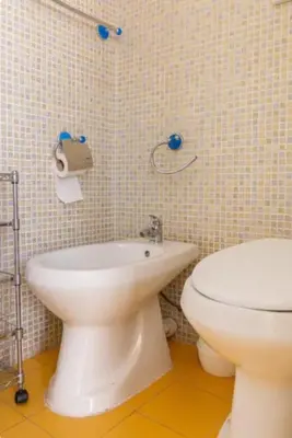 a bathroom with a toilet and a bidet at Il Canto di Euterpe in Palermo