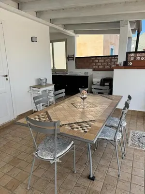 a table and chairs in a room with a chessboard on it at Il Canto di Euterpe in Palermo