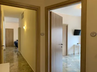 a hallway with a door leading to a room at A Casa di Giovi in Palermo