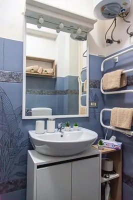 a bathroom with a sink and a mirror at vivà house in Palermo