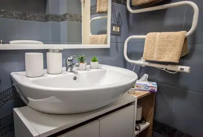 a bathroom with a white sink and a mirror at vivà house in Palermo