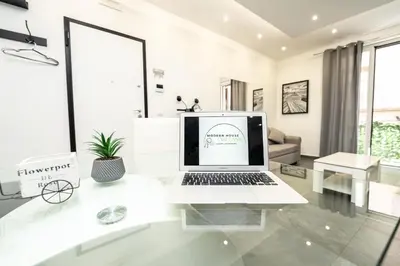 a white office with a laptop on a desk at Modern House Orleans in Palermo