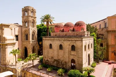 an old building with a tower and a church at Dimora degli Scalzi - Dive into Palermo's History in Palermo