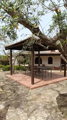 a picnic shelter with tables in front of a building at Villa Il Giardino di Rosa- 5 Min from the sea-Fraginesi in Castellammare del Golfo