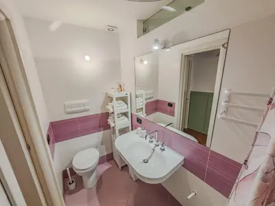 a bathroom with a sink and a toilet and a mirror at SANT'ELIGIO APARTMENTS & ROOMS in Palermo