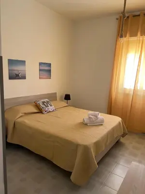a bedroom with a bed with a towel on it at Miramare in Balestrate