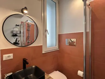 a bathroom with a black sink and a mirror at M'AMA apartment 1 in Ficarazzi