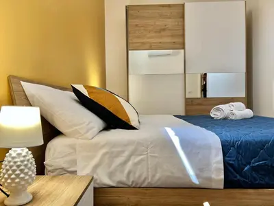 a bedroom with a bed with an umbrella on it at M'AMA apartment 2 in Ficarazzi