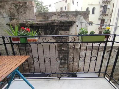 a balcony with a table with plants on it at Le due Marie in Palermo
