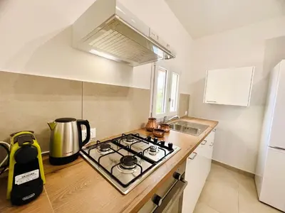 a kitchen with a stove top oven next to a refrigerator at L'Angolo del Saraceno in Carini