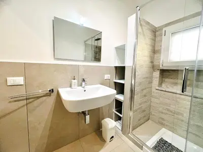 a bathroom with a sink and a shower at L'Angolo del Saraceno in Carini
