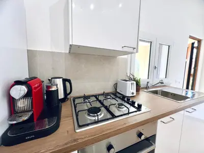 a kitchen with a red toaster on a stove at L'Angolo del Saraceno in Carini