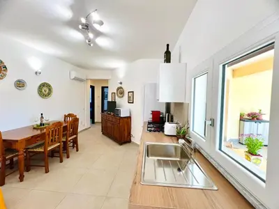 a kitchen and dining room with a sink and a table at L'Angolo del Saraceno in Carini