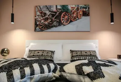 a bedroom with two beds and a painting on the wall at King's house apartments in Palermo
