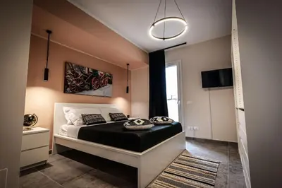 a bedroom with a bed and a large window at King's house apartments in Palermo