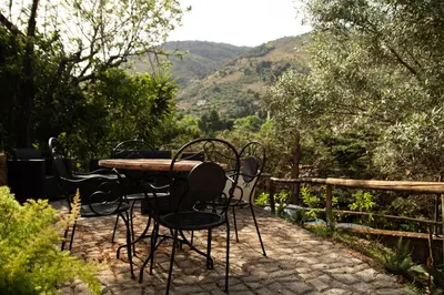 a table and chairs sitting on a patio with a view at Spera Luxury in Monreale
