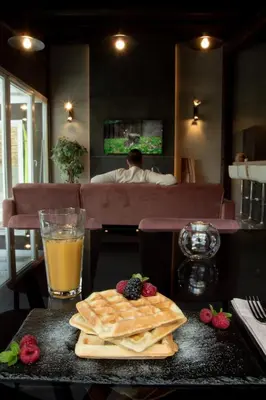 a table with a glass of orange juice and some food at Spera Luxury in Monreale