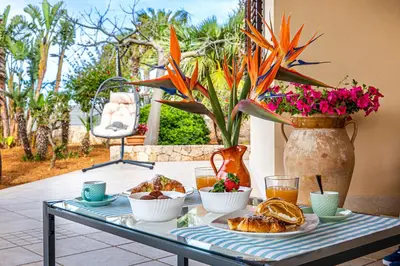 a table with a tray of food and drinks on it at Exclusive Palm House near the beach in Alcamo