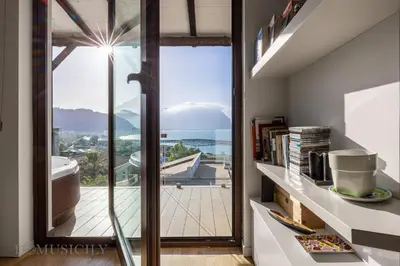 a bathroom with a large glass door with a view at Villa Maurino by DomuSicily in Mondello