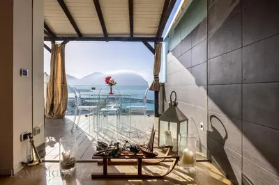 a room with a large window with a view of the ocean at Villa Maurino by DomuSicily in Mondello