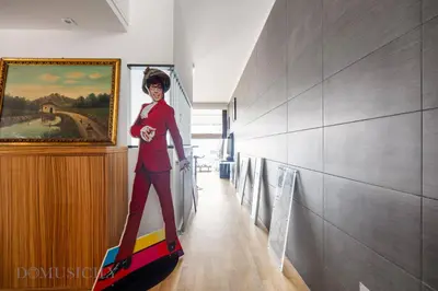 a person is standing on a surfboard in a room at Villa Maurino by DomuSicily in Mondello