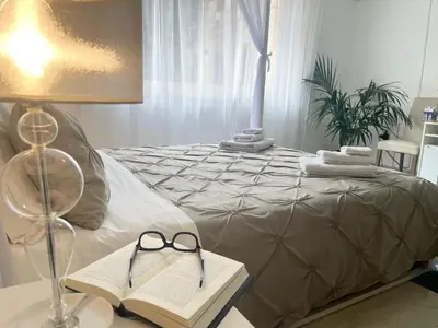 a bedroom with a bed with a lamp and a book at Al Politeama Rooms B&B in Palermo