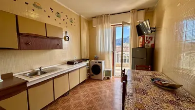 a kitchen with a sink and a refrigerator at Mondello SunSea in Mondello