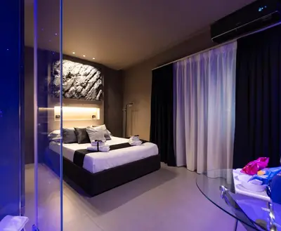a bedroom with a bed and a glass table at Platinum Suite&Spa in Palermo
