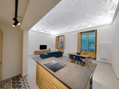 a kitchen and living room with a coffered ceiling at Ciuririvù in Palermo