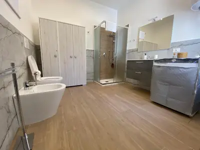 a bathroom with a sink and a toilet and a tub at Casetta al Molo Trapezoidale in Palermo