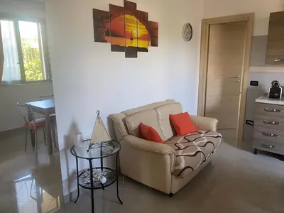 a living room with a couch and a table at Casa al mare in Lascari