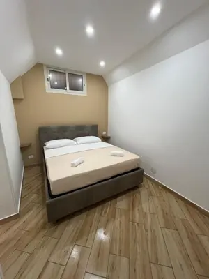 a bedroom with a large bed and a wooden floor at Incanto di luna Apartment in Palermo