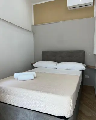 a bedroom with two beds with white sheets and pillows at Incanto di luna Apartment in Palermo