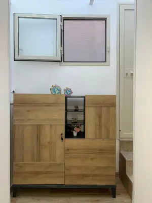a wooden cabinet in a room with a window at Incanto di luna Apartment in Palermo