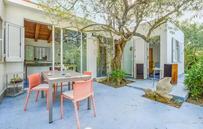 a patio with a table and chairs and a tree at Beautiful Home In Cinisi With Wifi in Cinisi