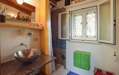 a bathroom with a bowl sink and a window at Beautiful Home In Cinisi With Wifi in Cinisi