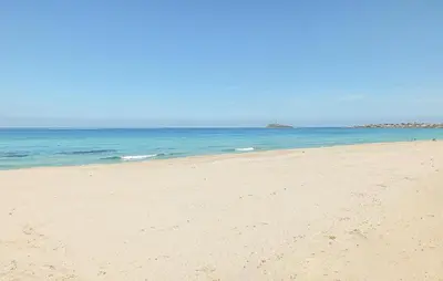 a sandy beach with the ocean in the background at Beautiful Home In Cinisi With Wifi in Cinisi
