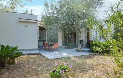 a house with a table and chairs in a yard at Beautiful Home In Cinisi With Wifi in Cinisi