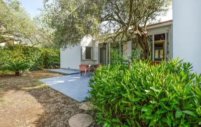 a white house with a table and chairs in a yard at Beautiful Home In Cinisi With Wifi in Cinisi