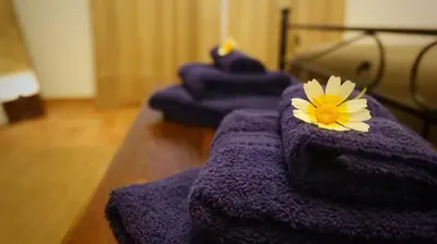 a row of purple towels with a flower on them at Villa Ginevra in Balestrate