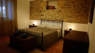 a bedroom with a bed with two night stands and two tables at Villa Ginevra in Balestrate